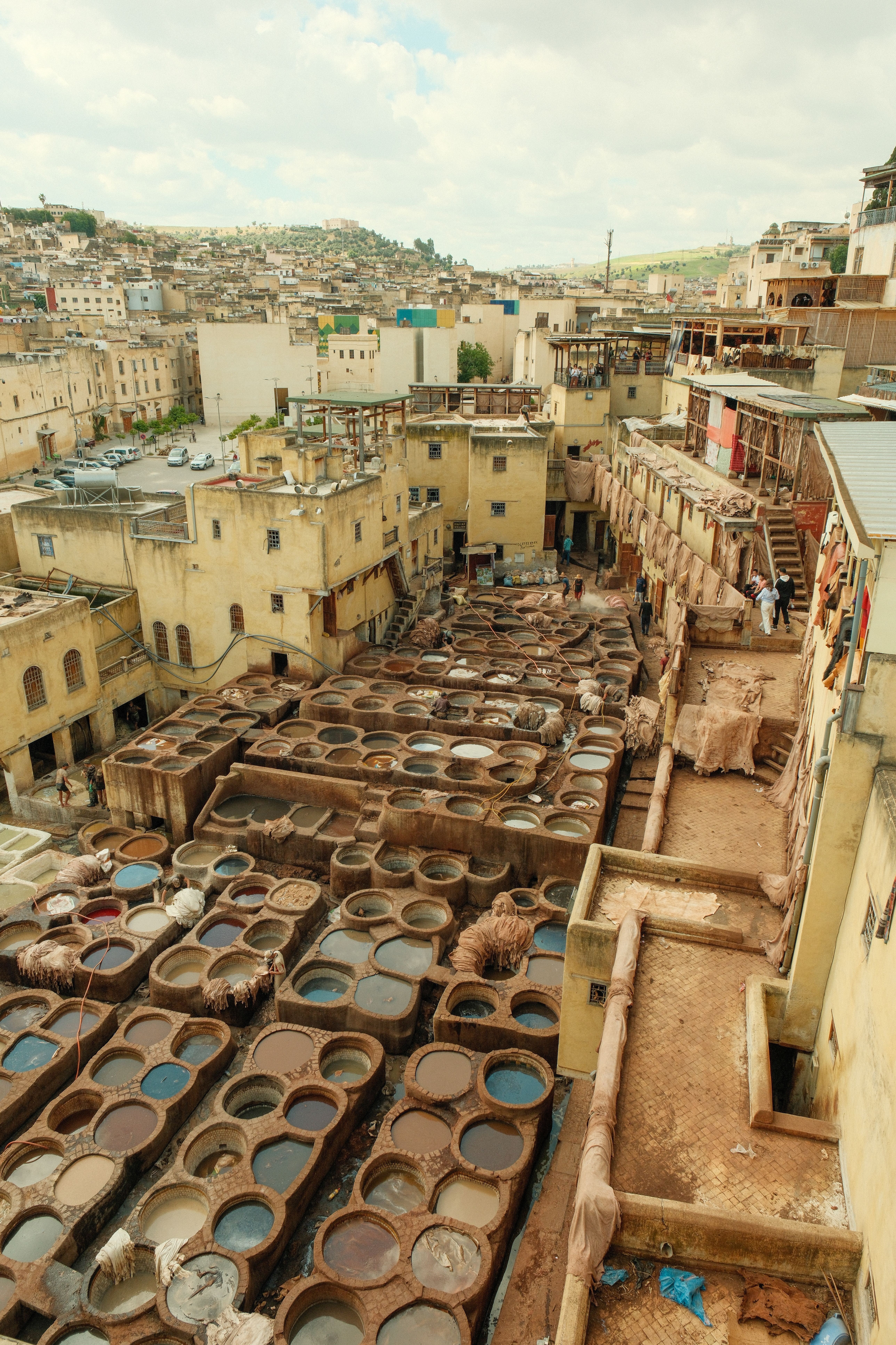 Aerial view of the historic leather tanneries in Fes, Morocco, showcasing traditional dyeing pits.