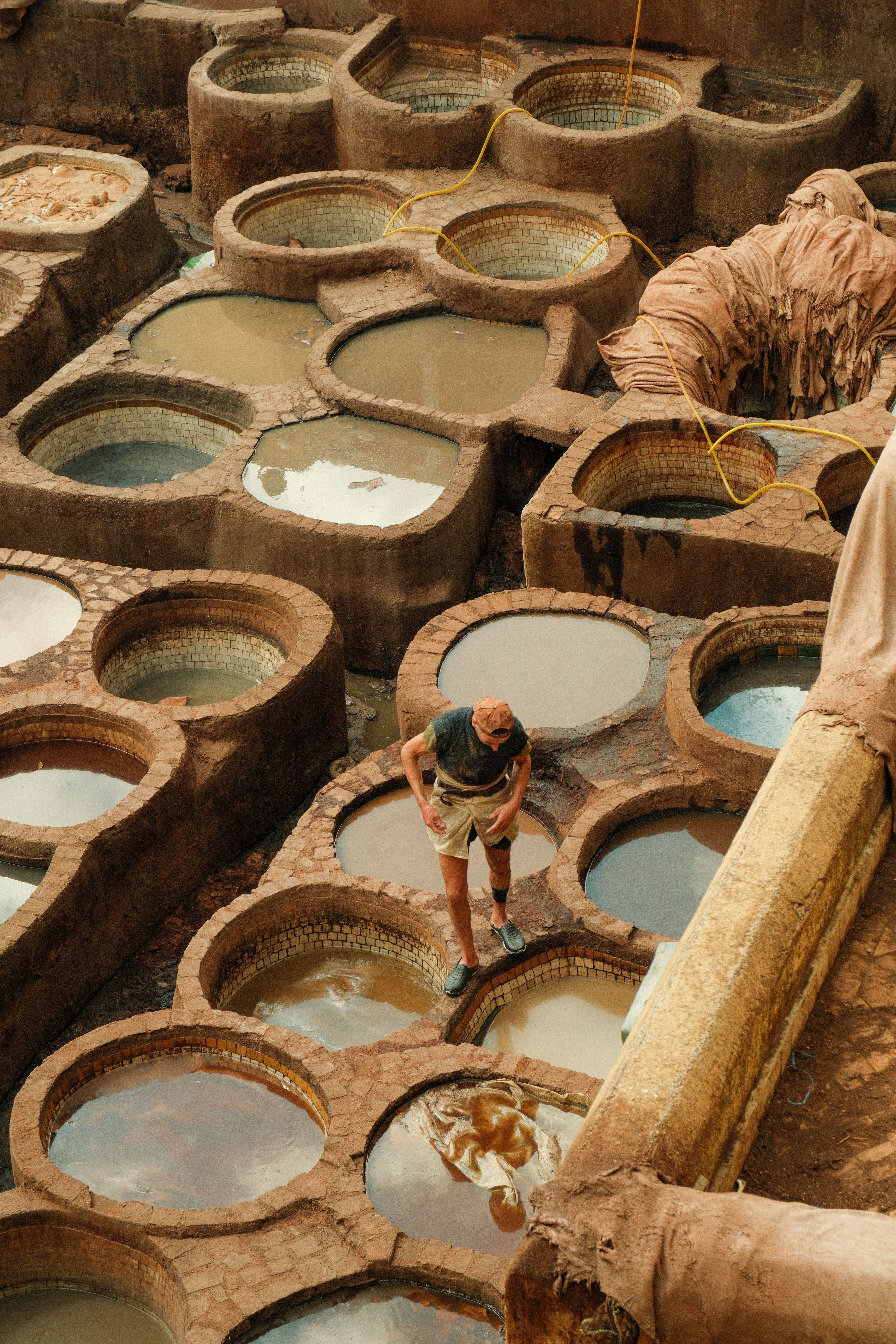 Aerial view of a traditional tannery in Fes, Morocco, showcasing vibrant dye pits.