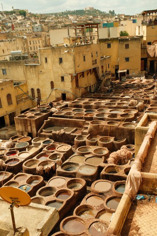 Free Aerial view of the iconic leather tannery in Fes, showcasing traditional dyeing vats. Stock Photo
