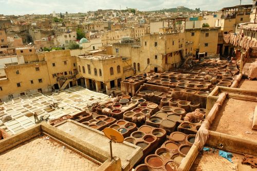 Free Aerial view of the vibrant traditional tannery in Fes' historic medina, showcasing colorful dye vats and architecture. Stock Photo