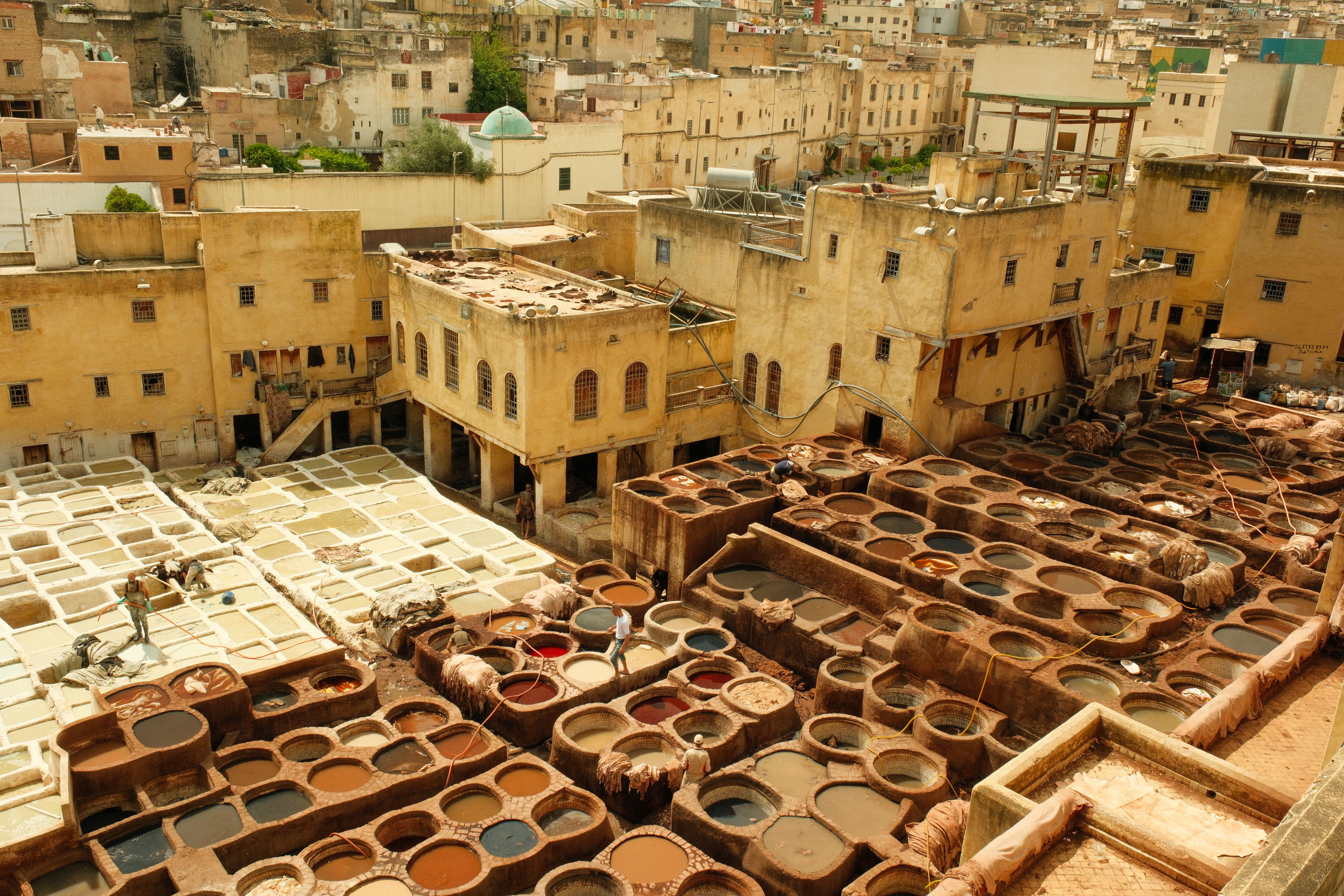 Aerial view of the historic leather tannery in Fez, Morocco, showcasing vibrant dye vats.