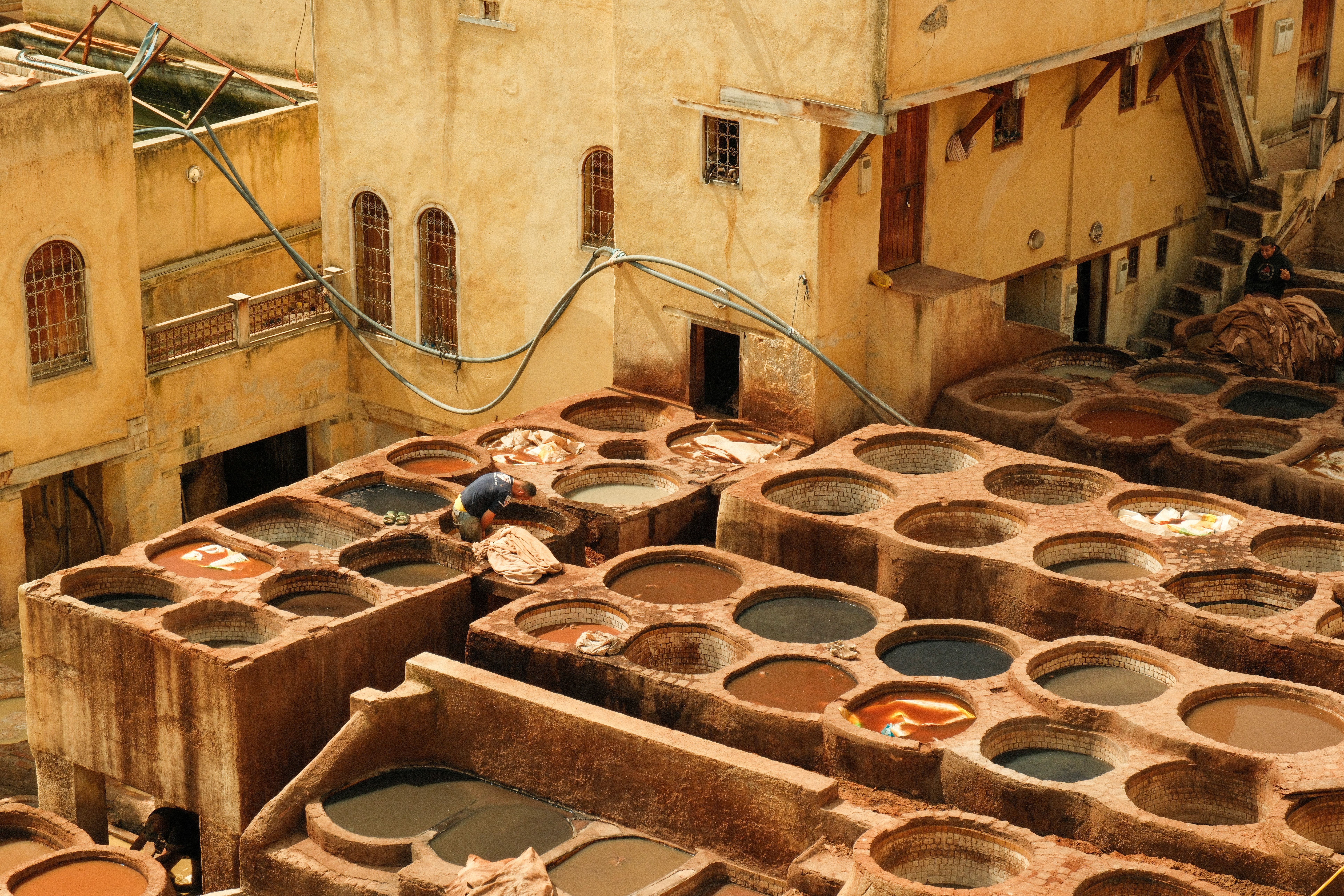 Aerial view of the iconic leather tanneries in Fes, Morocco, showcasing traditional industry.