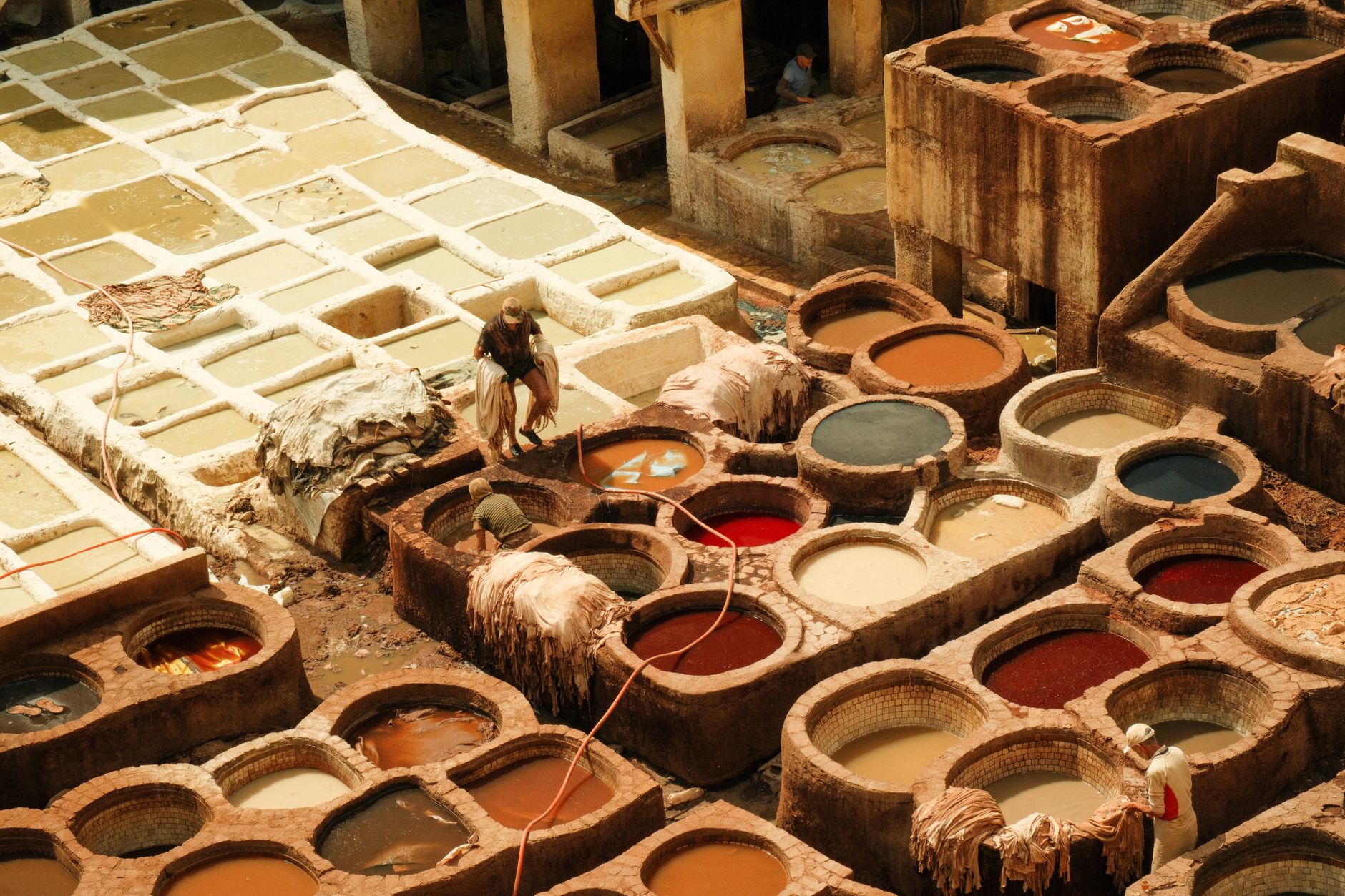 Aerial view of the vibrant and colorful leather tannery in Fes, Morocco, showcasing ancient dyeing techniques.