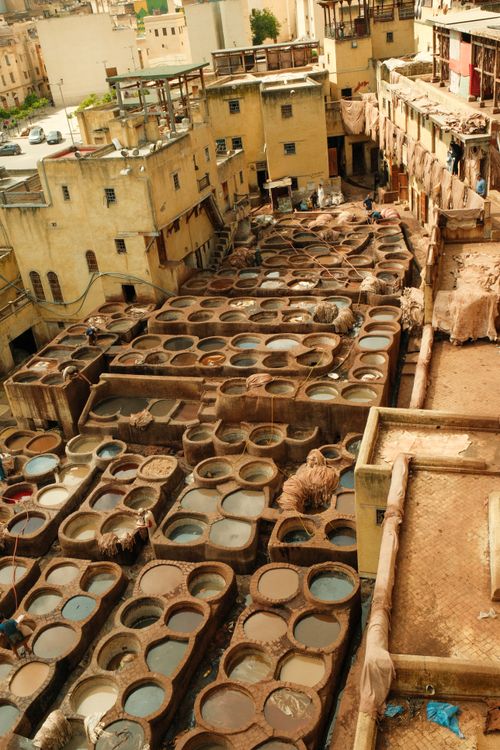 Free An aerial view of the traditional leather tanneries in Fes, Morocco showcasing vibrant dye pits. Stock Photo
