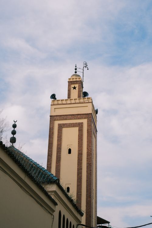 Free A beautiful minaret in Fes, Morocco against a clear blue sky showcasing Islamic architecture. Stock Photo