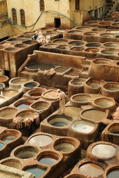 Aerial view of a traditional tannery in Fes, featuring colorful dye vats.