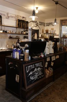 Warm and inviting coffee shop interior featuring rustic decor and coffee machine.