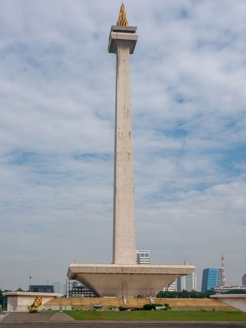 Free The iconic National Monument of Indonesia standing tall against a partly cloudy sky in Jakarta. Stock Photo