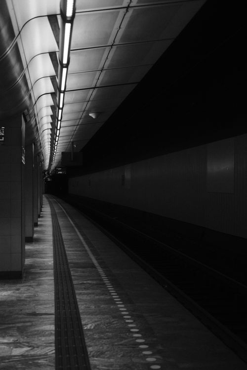 Free Black and white photo capturing the moody atmosphere of a Copenhagen subway station. Stock Photo