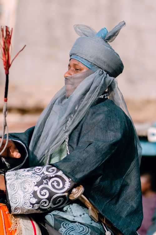 Free Close-up of a man in ornate, traditional garment riding a horse. Stock Photo