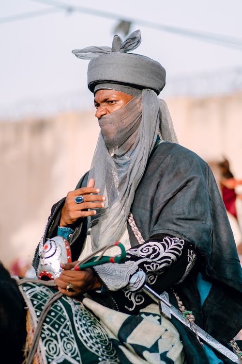 Free A traditional horseman dressed in ornate clothing rides during a cultural event, showcasing rich cultural heritage. Stock Photo