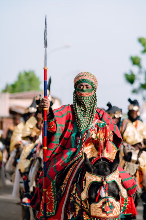 Free A Hausa horseman dressed in vibrant traditional attire participates in a cultural parade. Stock Photo