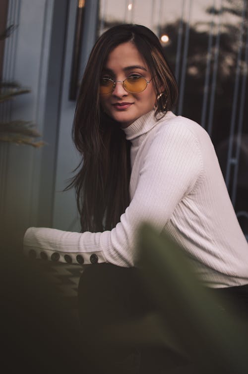 Woman in White Sweater Wearing Sunglasses