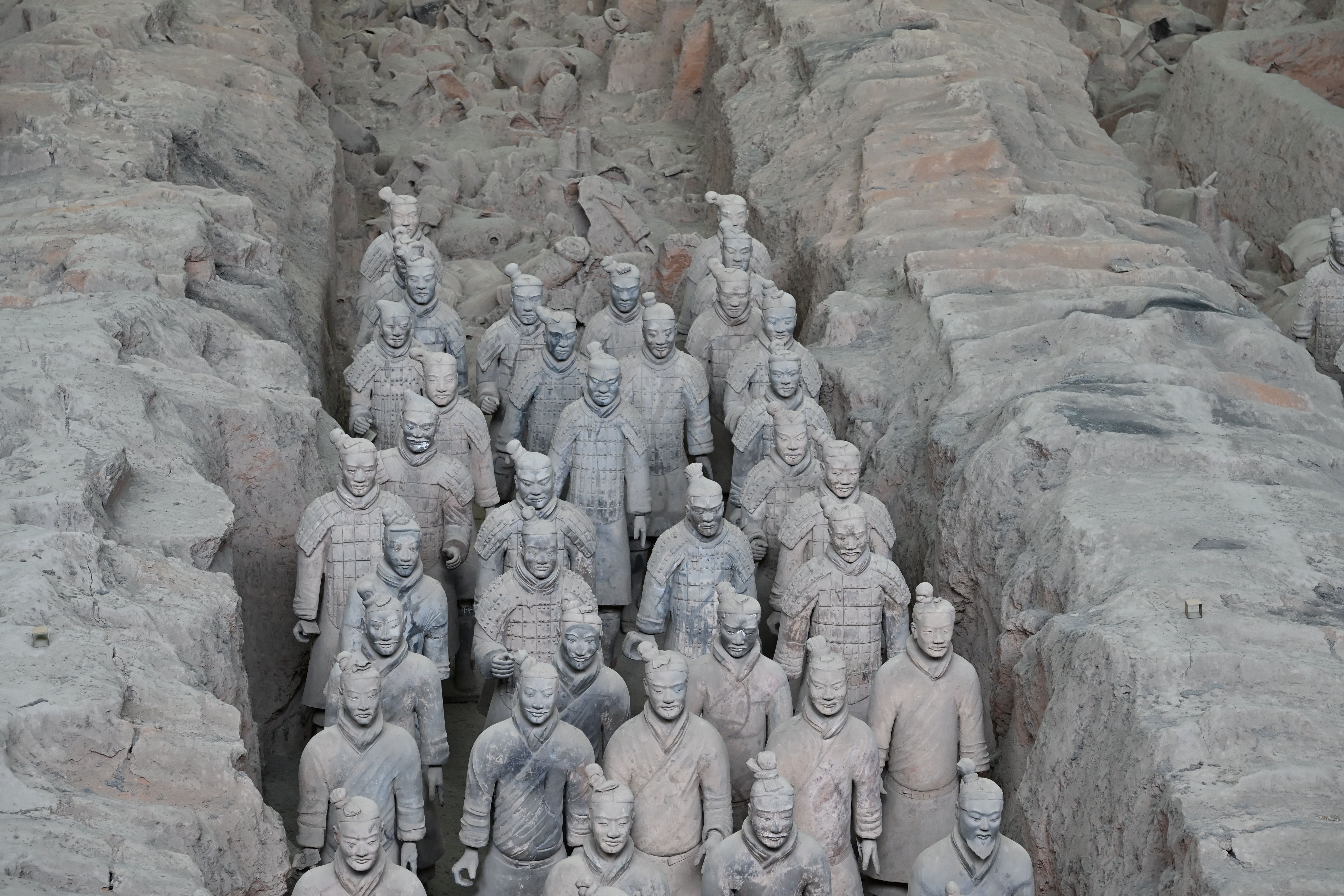 Ancient Terracotta Army site with rows of clay soldiers representing Qin Shi Huang's forces.
