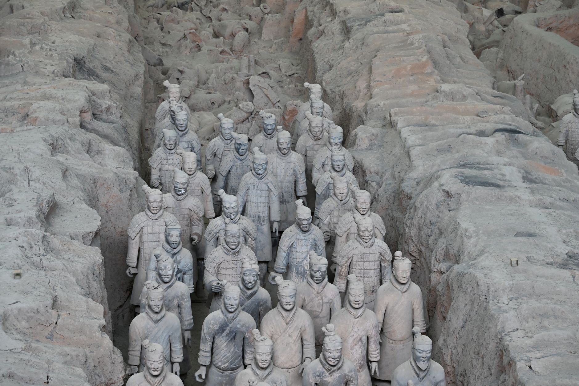 Ancient Terracotta Army site with rows of clay soldiers representing Qin Shi Huang's forces.