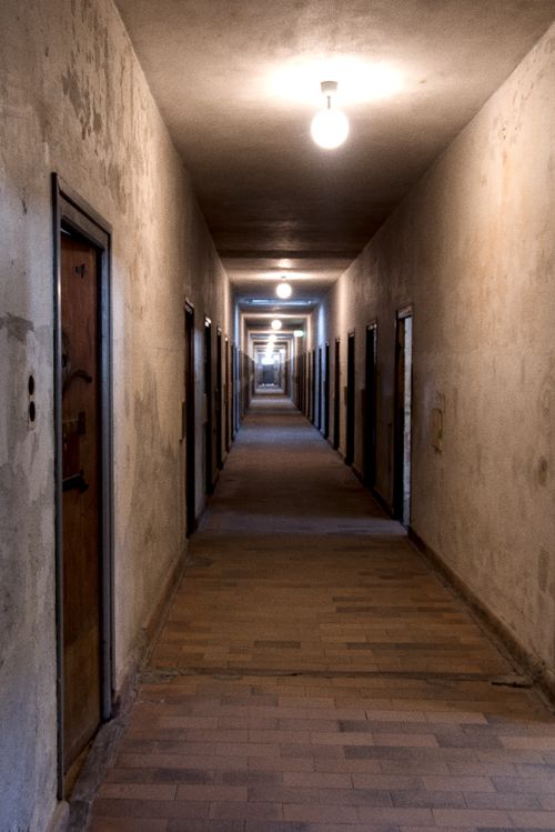 Free Dimly lit hallway at Dachau, Germany, showcasing historical architecture and solemn atmosphere. Stock Photo
