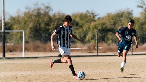 Free Two teenage soccer players in action outdoors on a sunny day. Stock Photo