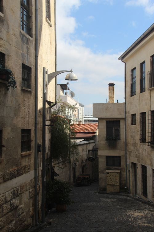 Free Charming narrow alleyway with old stone buildings and rustic charm in a historic district. Stock Photo