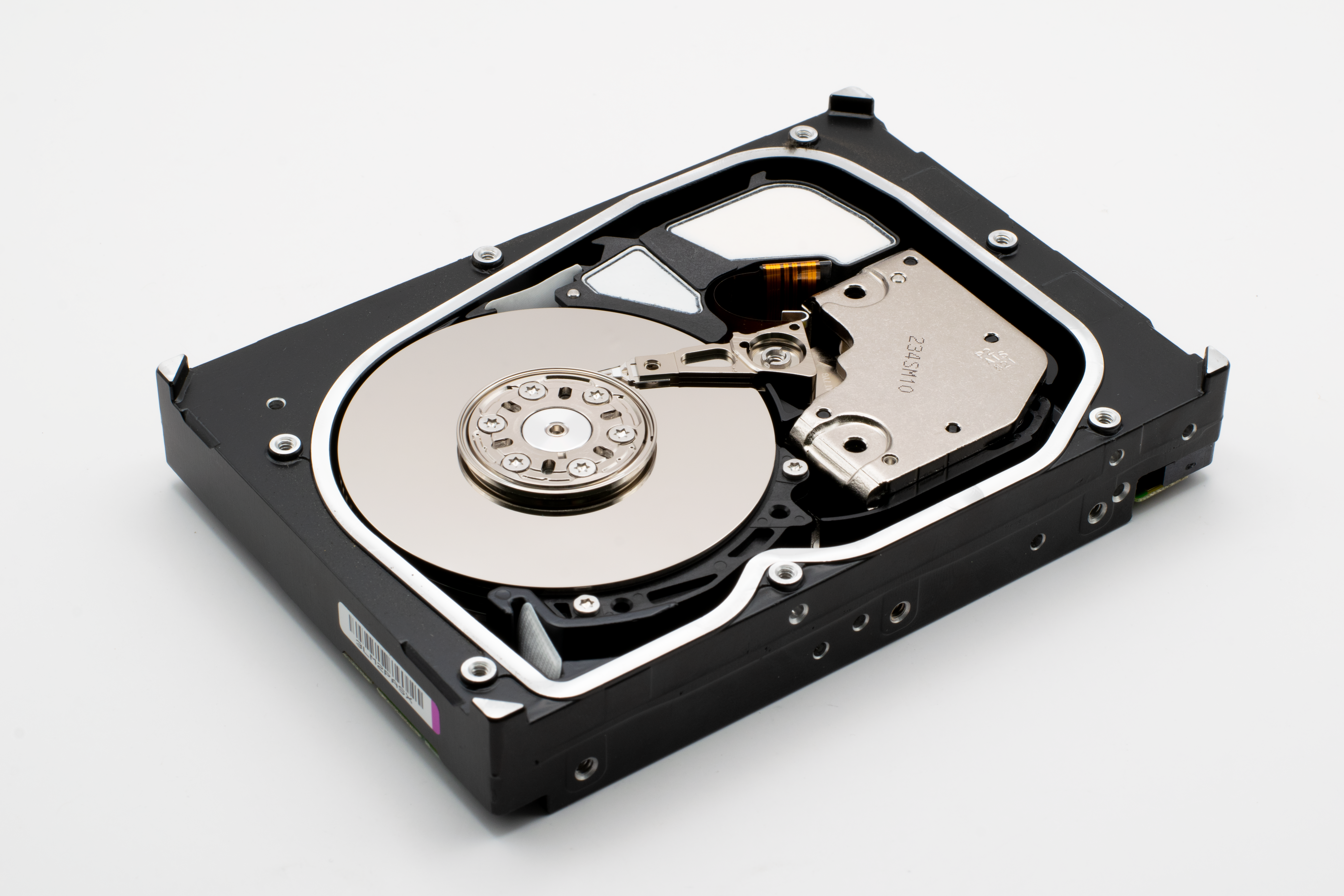 Detailed view of an open internal hard disk drive showing platters and read/write arm.