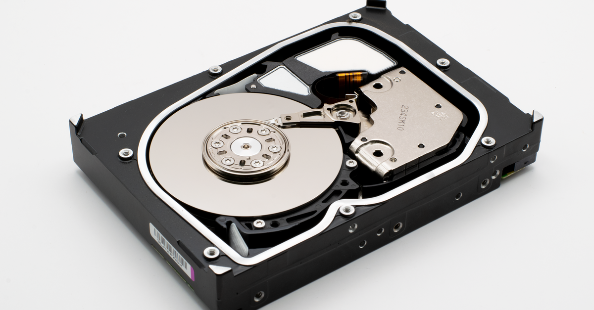 Detailed view of an open internal hard disk drive showing platters and read/write arm.