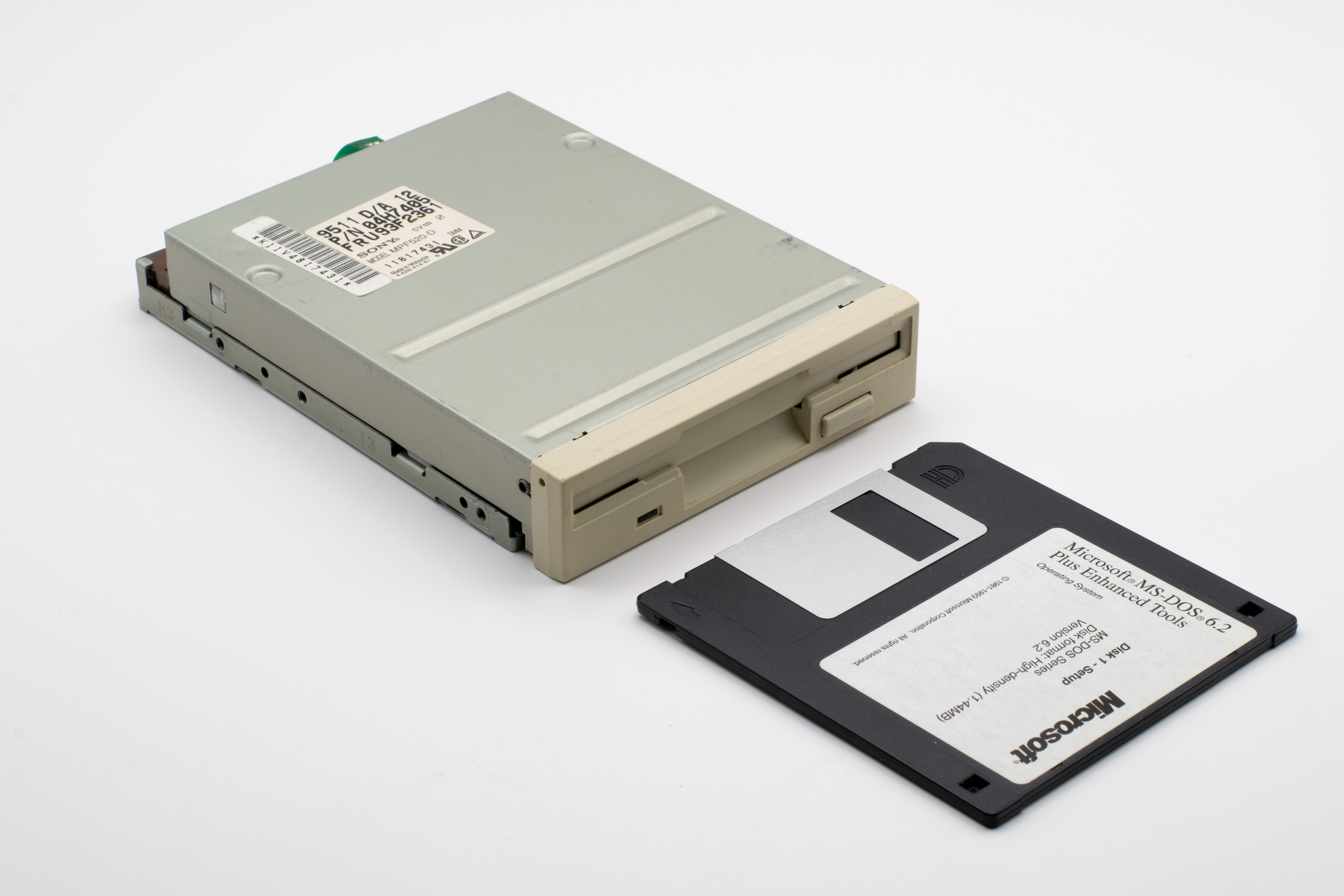 Classic 3.5-inch floppy disk drive with a Microsoft MS-DOS 6.2 diskette.