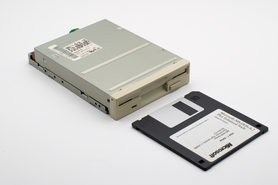 Classic 3.5-inch floppy disk drive with a Microsoft MS-DOS 6.2 diskette.