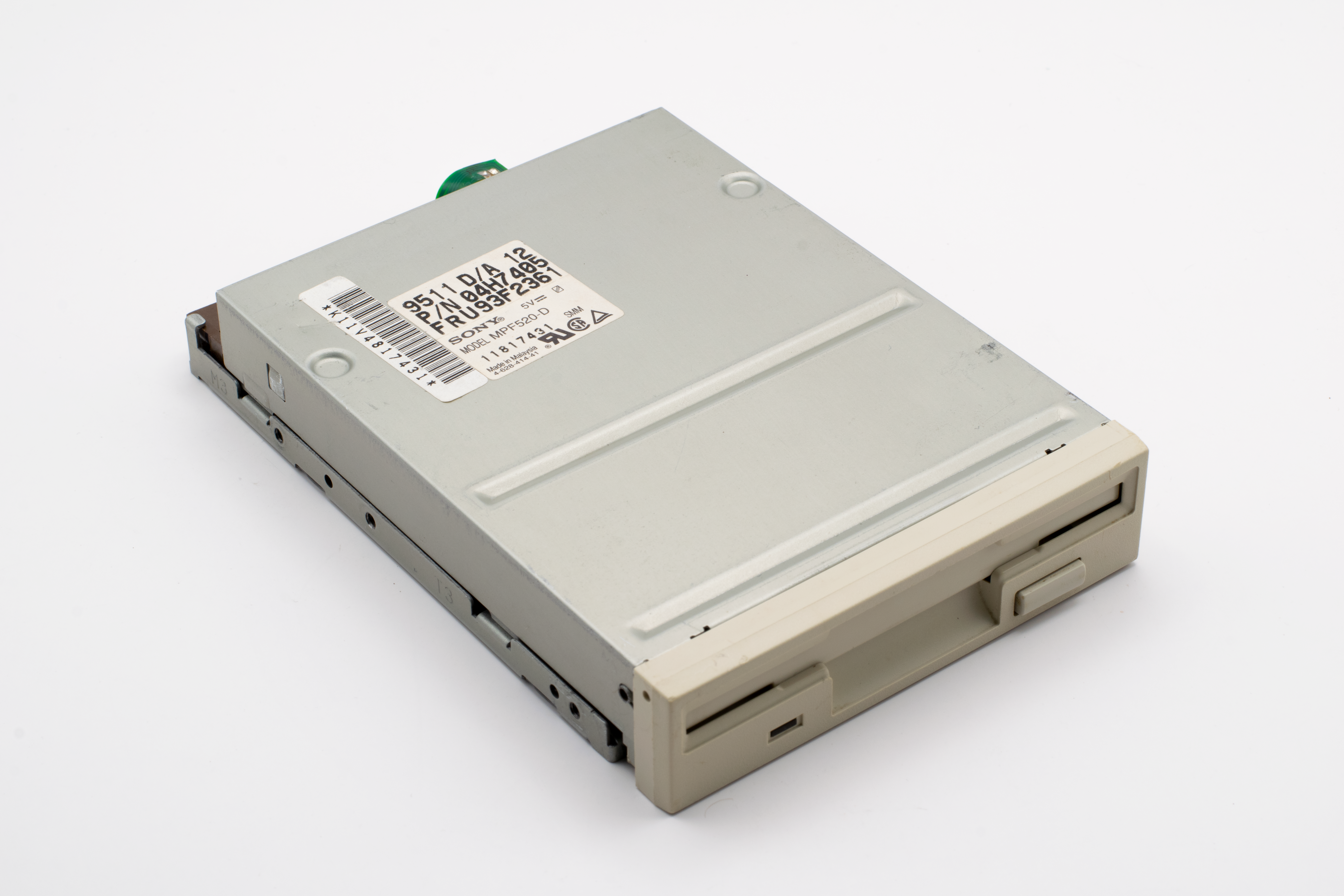 A retro floppy disk drive showcasing historical computer technology from the 1990s era.