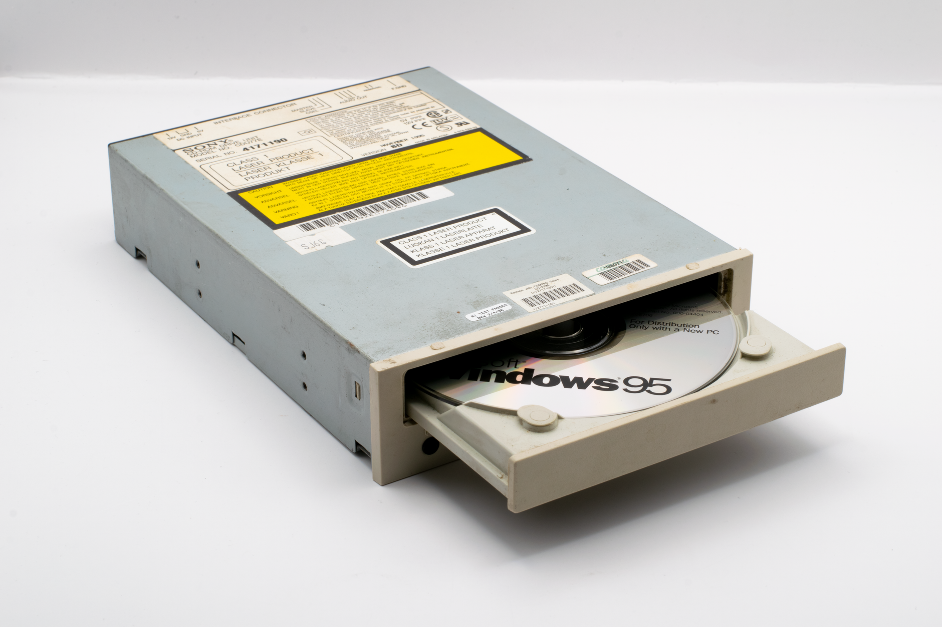 A vintage CD-ROM drive showcasing a Windows 95 disc, reflecting retro technology.