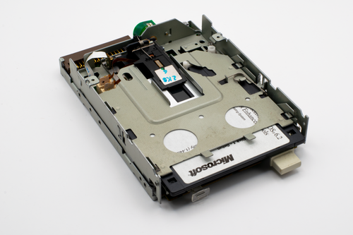 Free Close-up of a retro floppy disk drive with visible Microsoft label, showcasing historical technology. Stock Photo