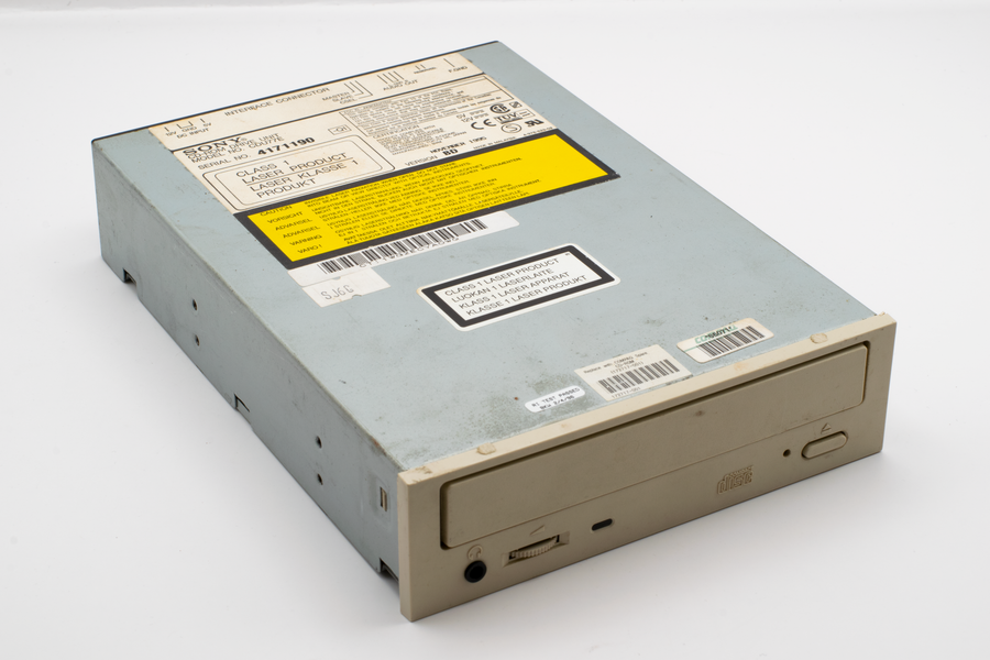 Close-up of a retro Sony CD drive showcasing labels and vintage design.