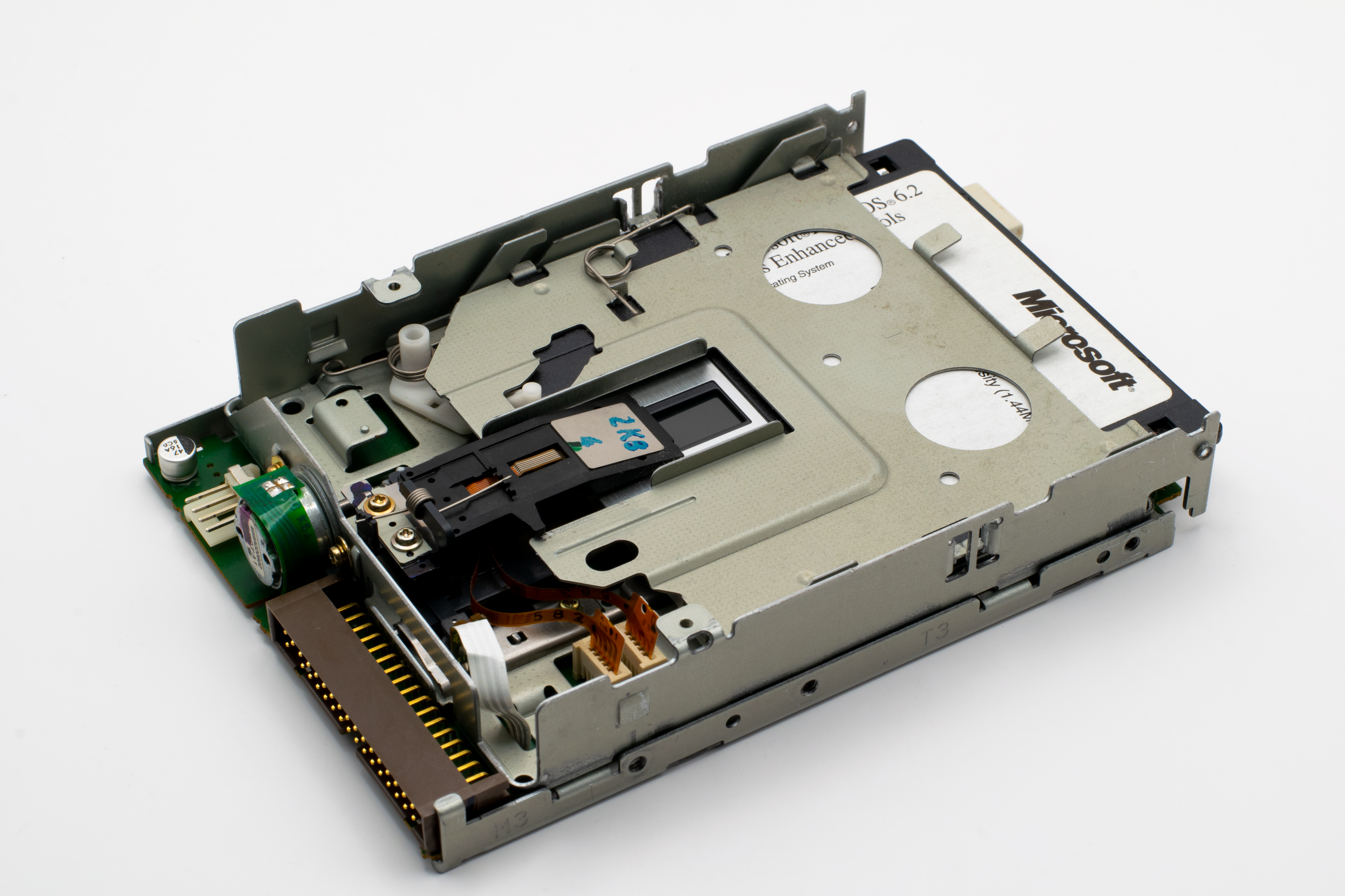 Detailed view of a vintage Microsoft floppy disk drive showcasing retro technology components.