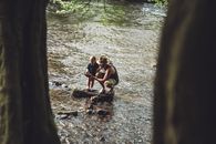 Photo of Man and Child on Rock