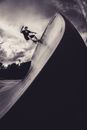Monochrome Photo of Man Skateboarding on Skate Ramp