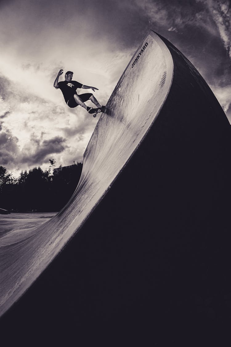 Monochrome Photo Of Man Skateboarding On Skate Ramp