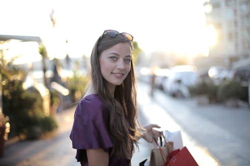 Shallow Focus Photo of Woman Carrying Shopping Bags