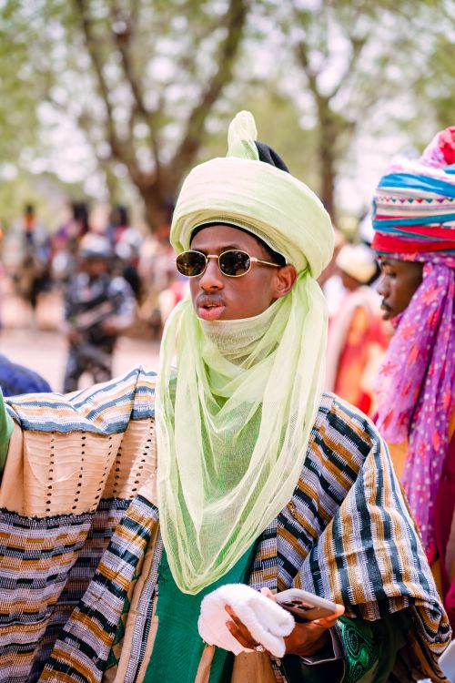 Free A man in traditional Hausa attire at a vibrant cultural festival outdoors during the day. Stock Photo