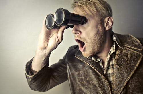 Free Man in Brown Leather Jacket Using Binoculars Stock Photo