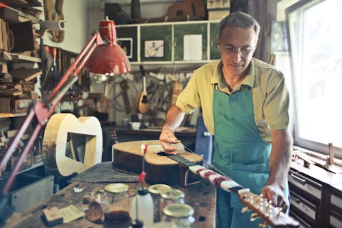 Photo D'un Homme Fabriquant Une Guitare Acoustique