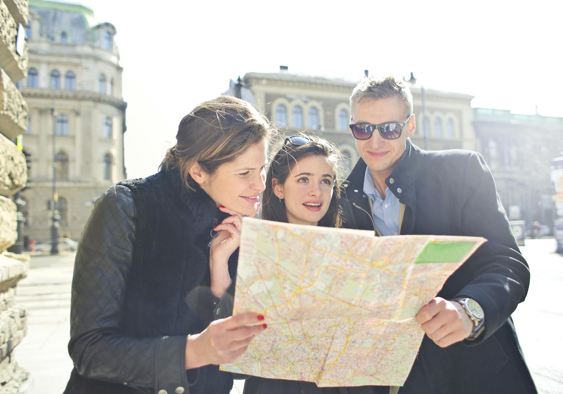 People Reading Map in the Middle of the Street