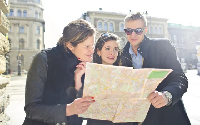 Travellers planning a route with a map