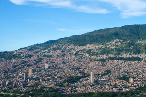 Free Explore the dynamic city of Medellín nestled in lush green mountains under a clear blue sky. Stock Photo
