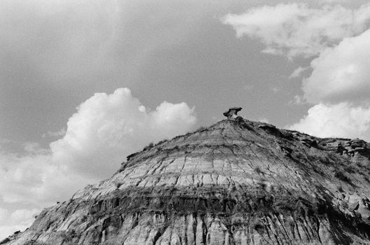 A striking black and white view of the Drumheller hoodoos under a cloudy sky.
