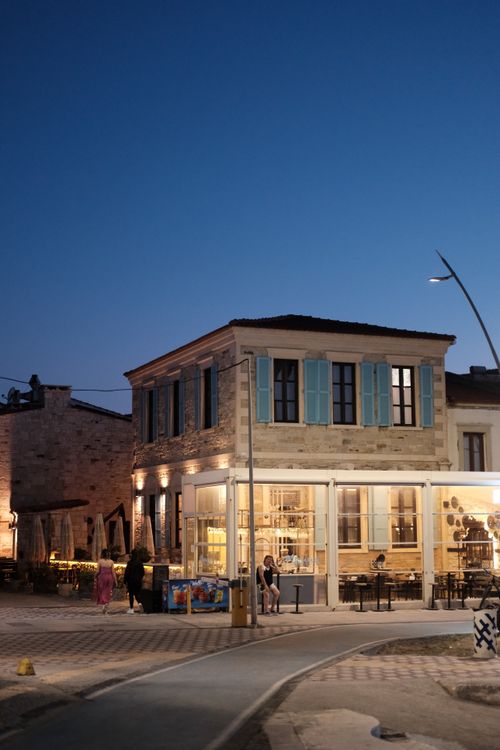 Free Lively street scene of a café in Foça, İzmir at twilight. Relaxing atmosphere. Stock Photo
