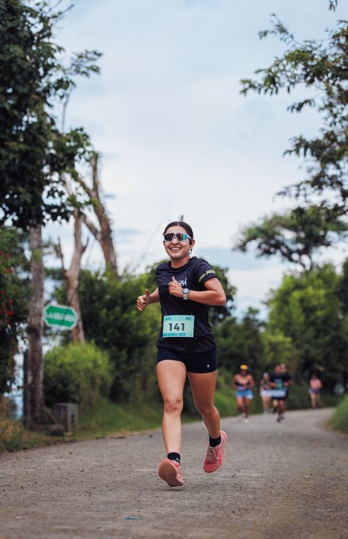 Free Smiling female runner in a race, captured outdoors in Pereira, Colombia. Stock Photo