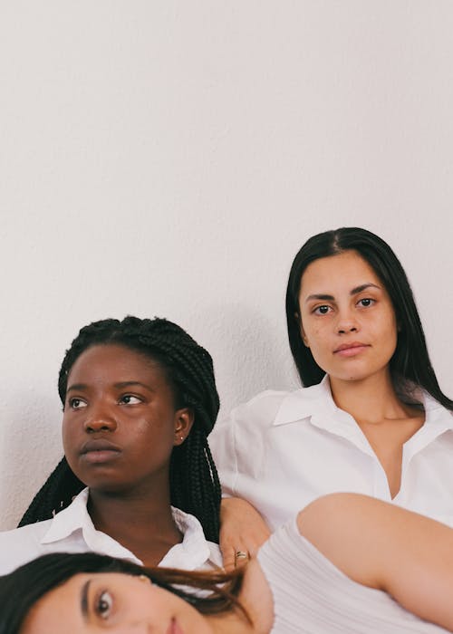 Women Looking Serious Against White Background