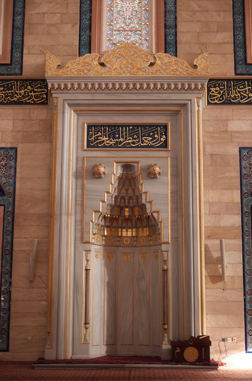 Free Detailed view of an ornate mihrab inside a mosque, showcasing Islamic architectural design. Stock Photo
