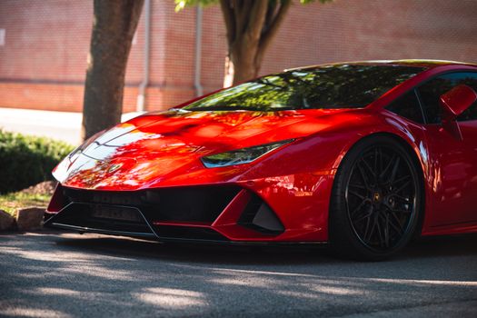 Vibrant red sports car parked outdoors, showcasing sleek design and modern elegance.