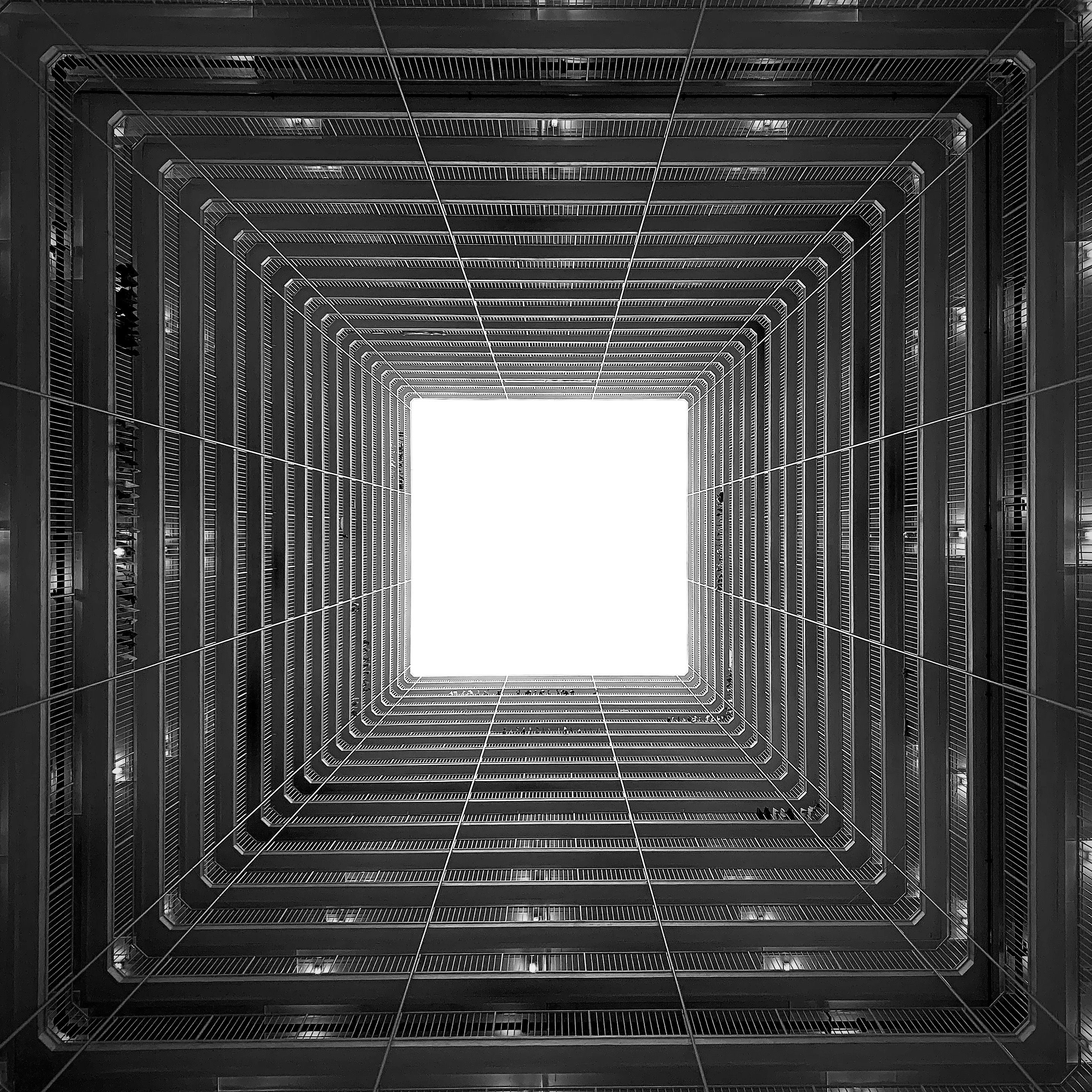 Dramatic black and white view from inside a Hong Kong residential building.