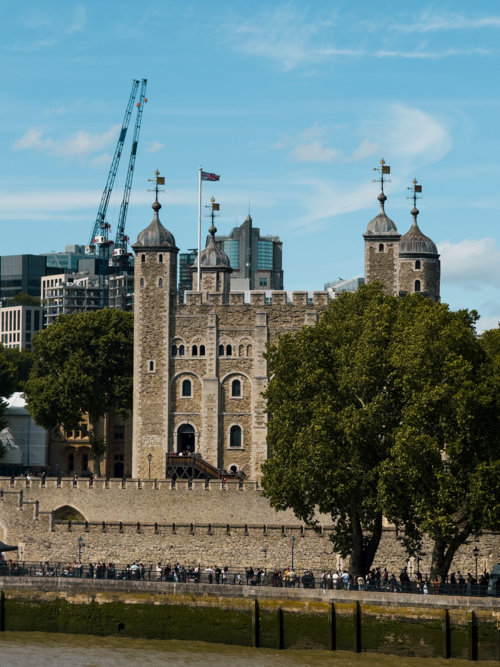The White Tower and battlements of the Tower of London against the city skyline