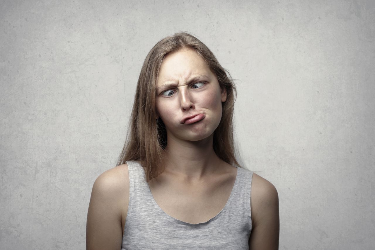 a woman with long hair making a silly expression adding humor to an ot